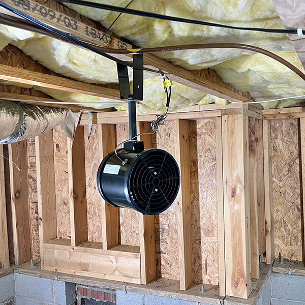 Photo of an Interior Crawl Space Fan System installed on a pier and beam structure to circulate air and manage humidity in a Dallas-area home foundation.
