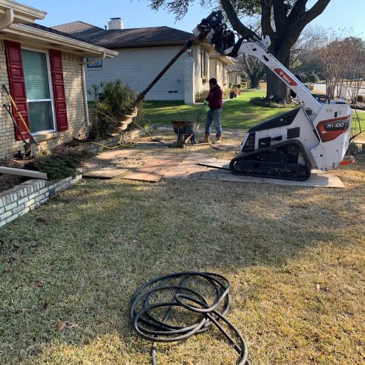 foundation repair using auger on home exterior