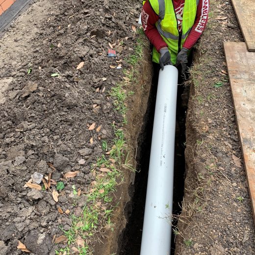 overhead view of drain pipe installation in trench