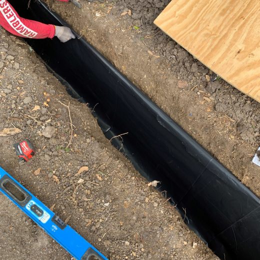 trench along exterior of the property to repair drainage